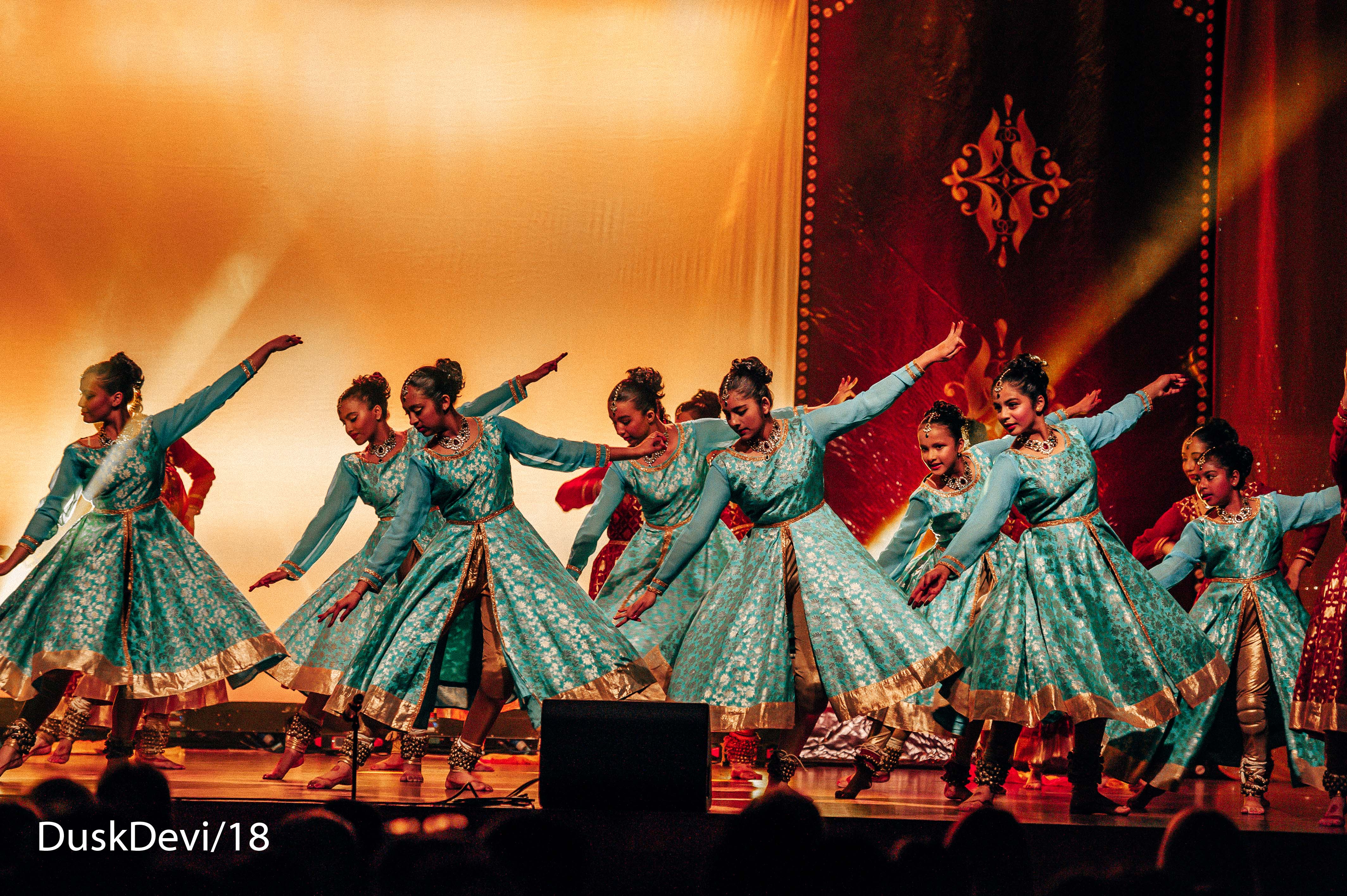 Ruchi Sanghi Dance Company Performances Banner dancers in action arms outstretched on stage